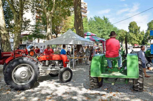 Deux tracteurs dont un transportant un monsieur de dos
